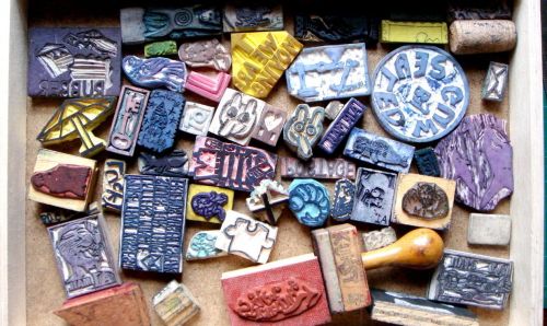 A drawer that is full of rubber stamps.